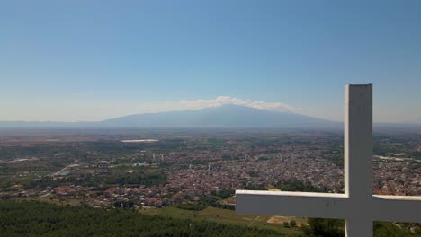 Aerial-drone-4k-clip-taking-off-over-the-mount-of-Korilovos-in-the-area-of-Drama-in-Northern-Greece,-next-to-a-big-cross-on-the-top-of-the-mountain