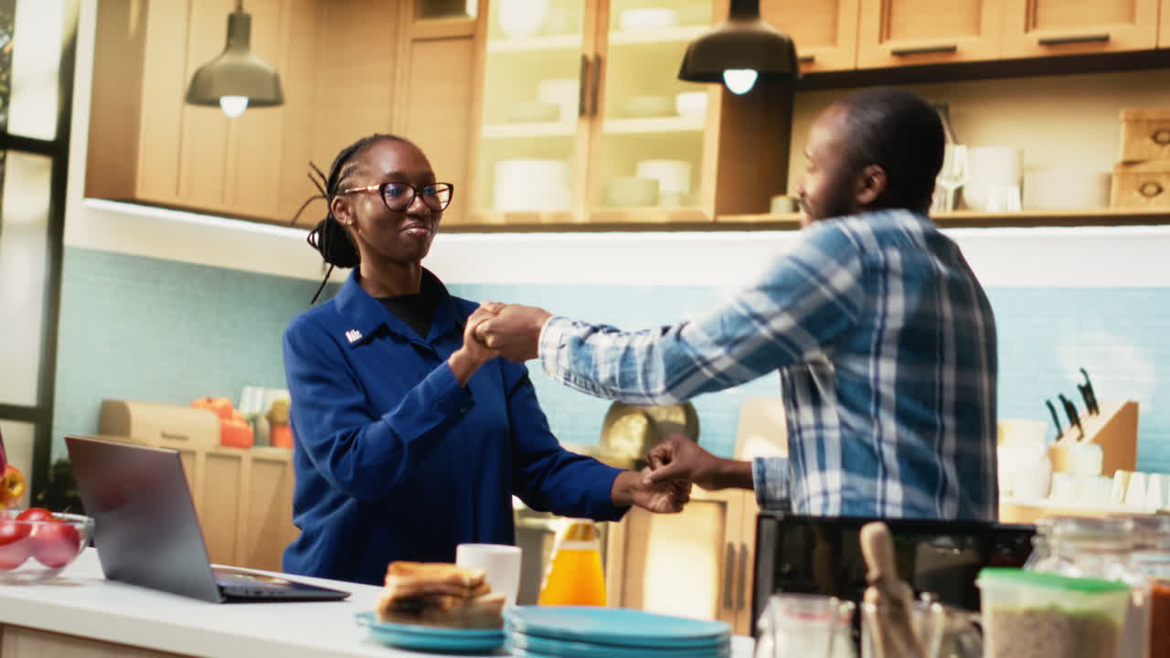People greeting each other in a kitchen