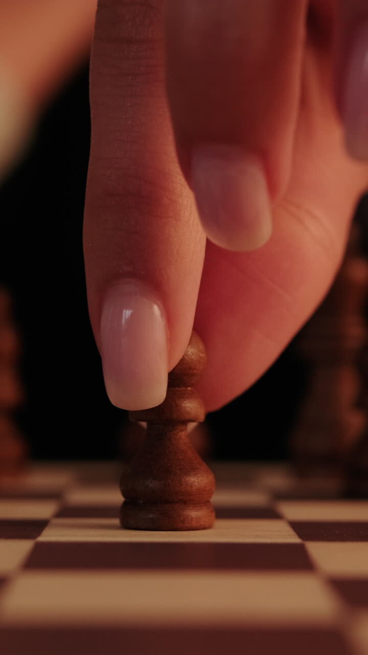 Woman Playing Chess, Moving a Pawn