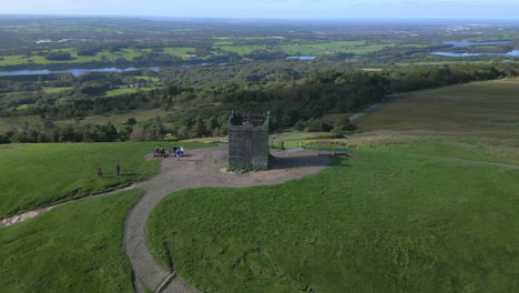 Stone-structure-on-hilltop-with-tourists