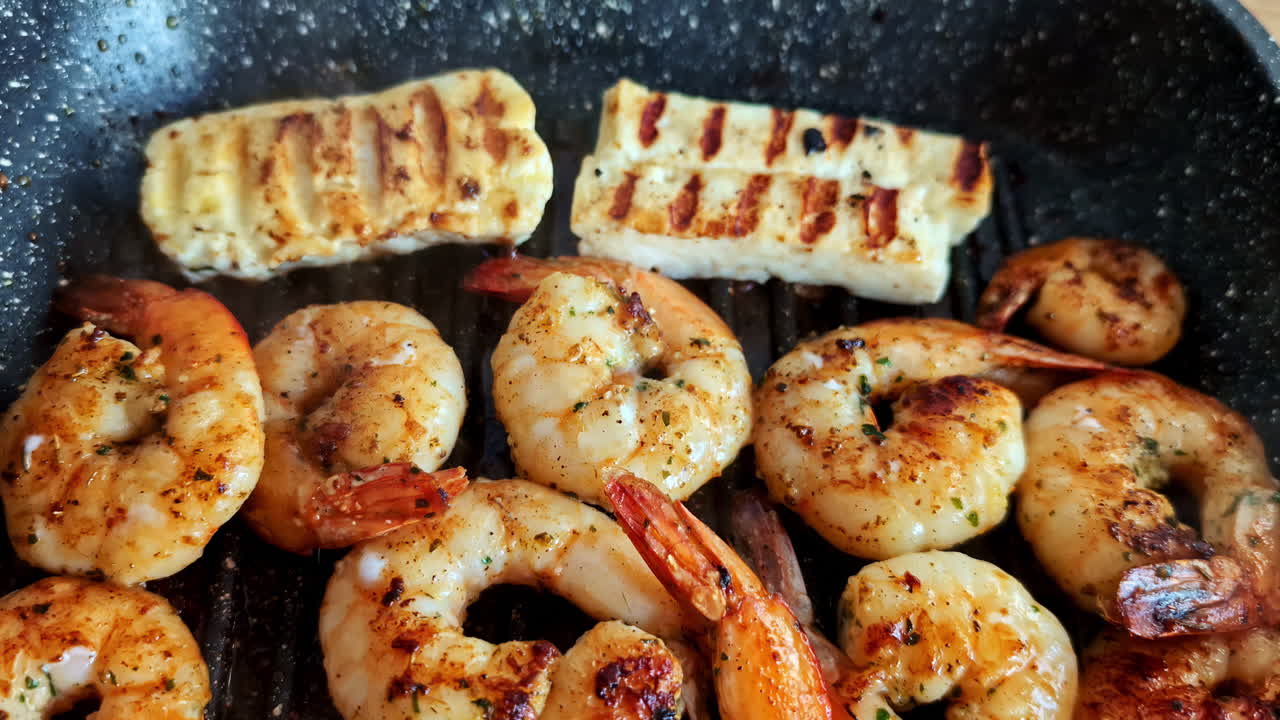 Delicious home-made shrimps with melted cheese cooking in a pan, perfect for a cozy meal