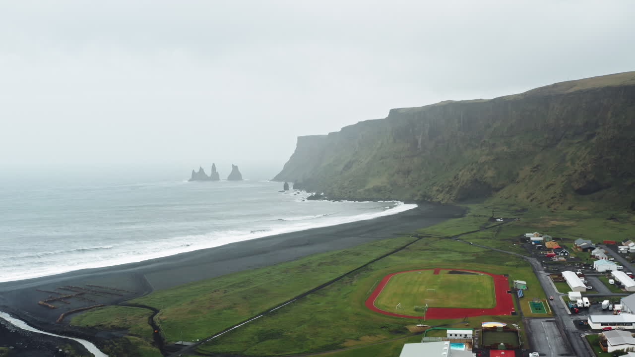 Aerial Drone view over Black Sand Beach in V&iacute;k &iacute; M&yacute;rdal - Iceland Dramatic misty view over Icelandic Coastline