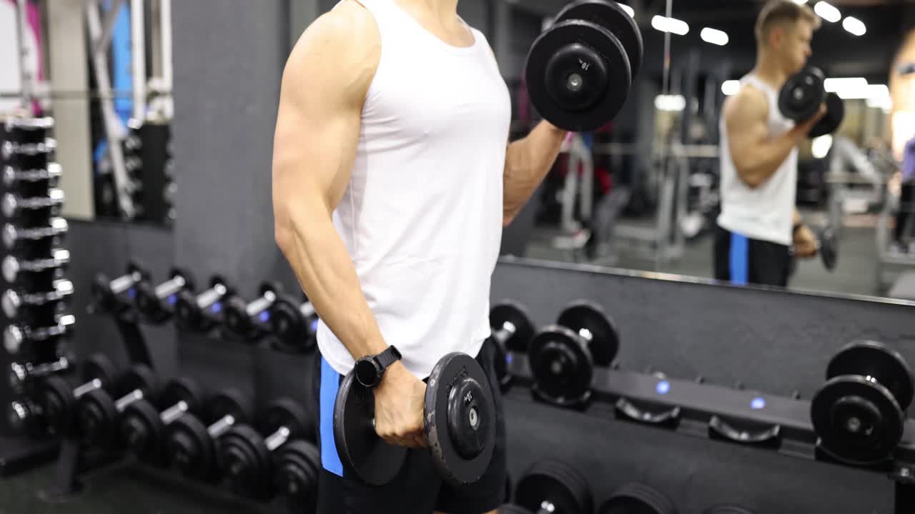 Man doing dumbbell curls at the gym