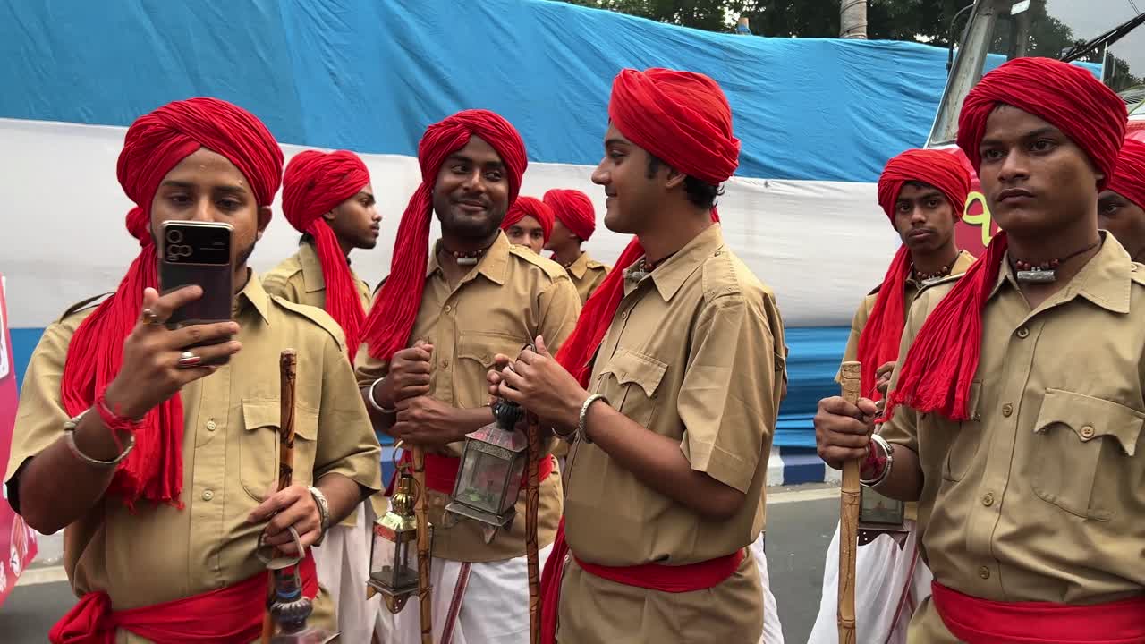 Closeup shot of men dressed in Khaki uniform during British Raj as Indian police at Durga puja procession in Red road of Kolkata, India.