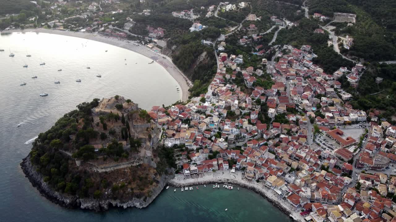 Panoramic drone shot of Parga town breathtaking natural landscape and traditional architecture at sunset, Greece