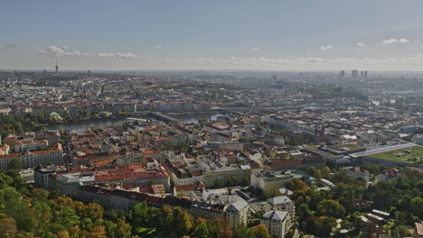 Prague-Czechia-Aerial-v41-cinematic-flyover-Petrin-hill-capturing-cityscape-of-Smichov-and-views-of-New-town-and-downtown-across-Vltava-river-on-a-sunny-day---Shot-with-Mavic-3-Cine---November-2022