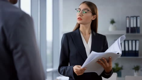 a businesswoman reviews documents in an office