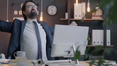 businessman stretching in office