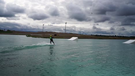 young man wake boarding in the water park