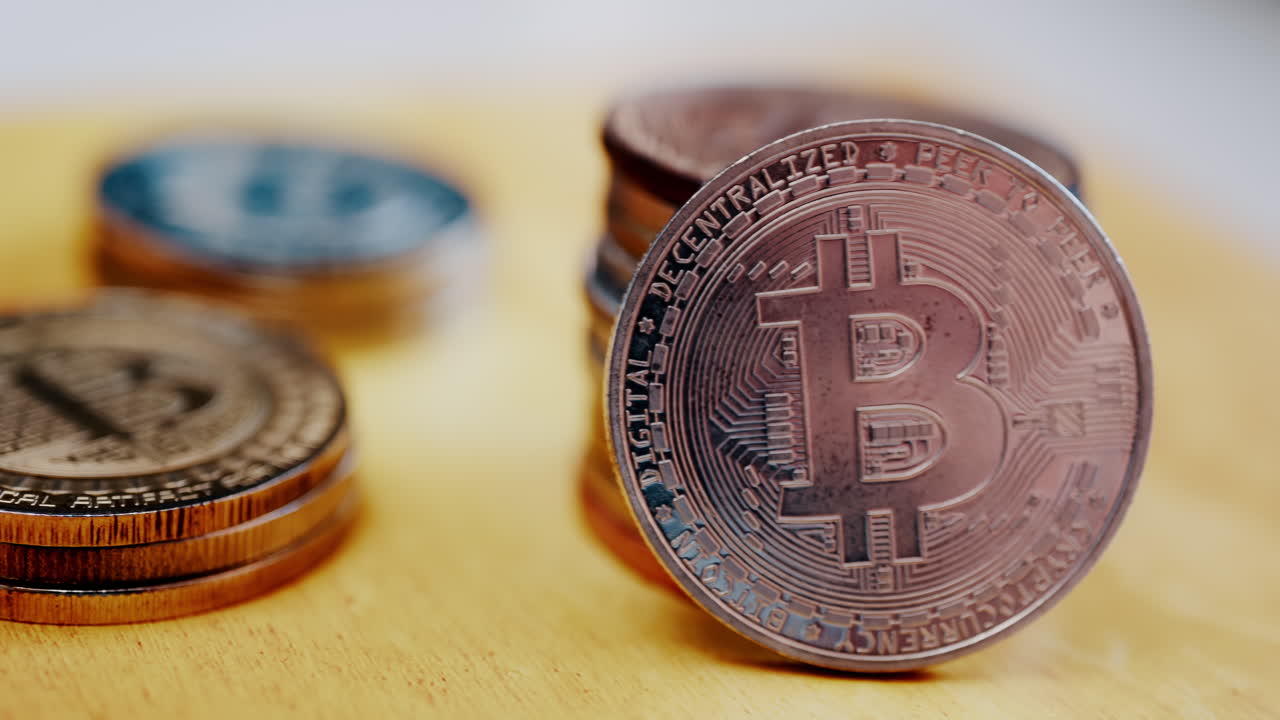 Close up of shiny physical Bitcoin coins stacked on a table