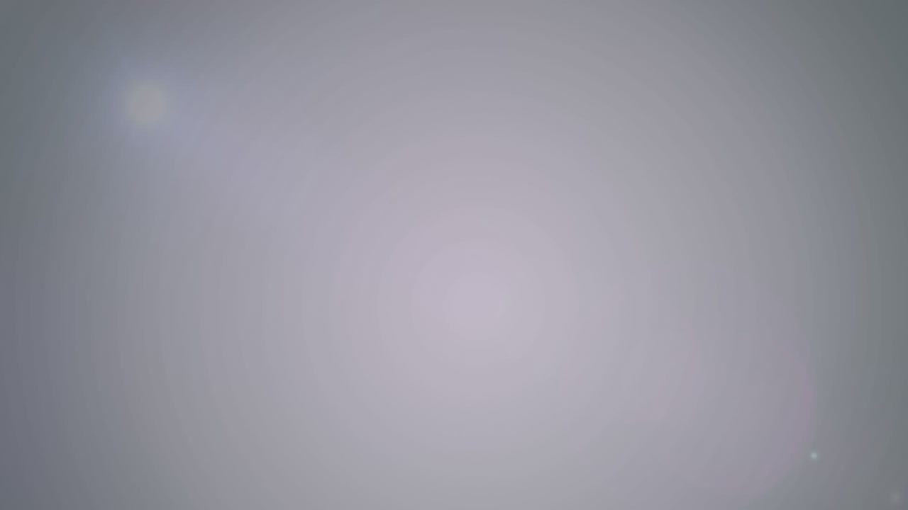 Animation of colourful light spots moving over gray background