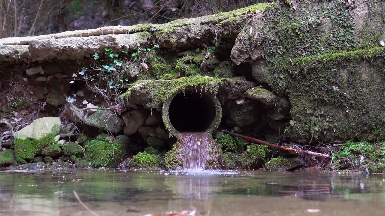 Sewage pipe throwing slurry in a river