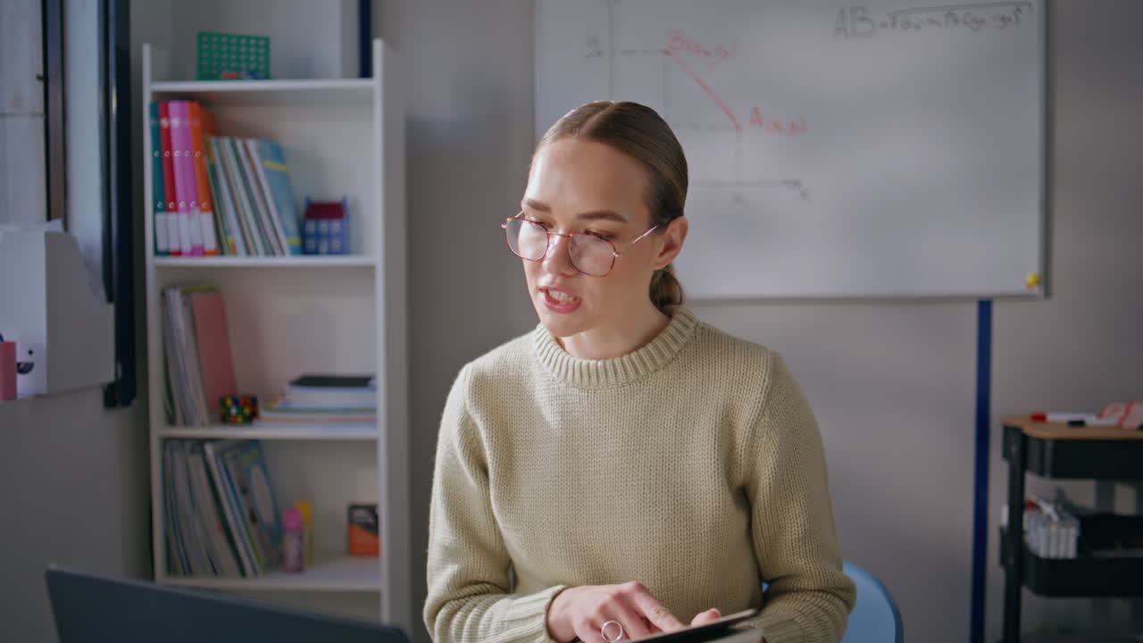 School woman reading online lesson at cabinet closeup. Distance teacher talking