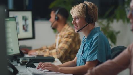 business team wearing headsets working late at customer support centre