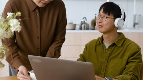 Couple working from home, video call in kitchen