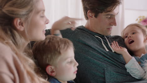 happy family using tablet computer at home mother and father with children watching entertainment playing game on touchscreen device learning having fun together 4k footage