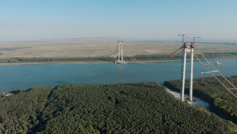 aerial view of brăila bridge in romania, under construction over the danube river - drone shot