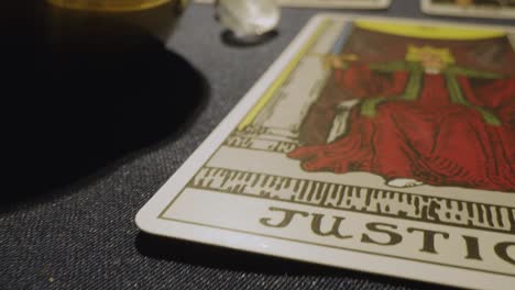 close up shot of tarot cards laid out for reading on table with candles