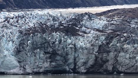 close shot of a glacier covered with volcanic dust in glacier bay national park, alaska