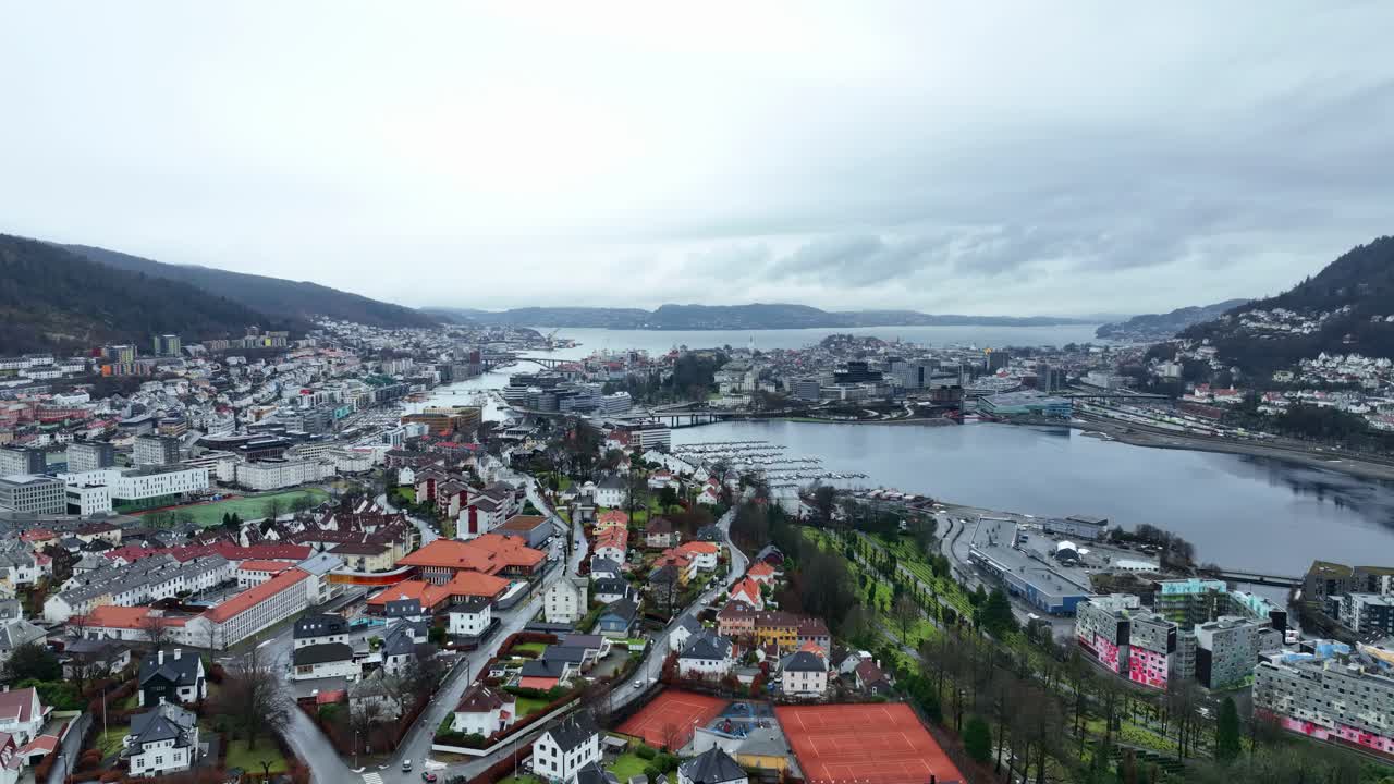 Rising aerial over Bergen, Norway, from Haukeland towards the city center, Byfjorden, Puddefjord, and Lille Lungegard. Winter, no snow