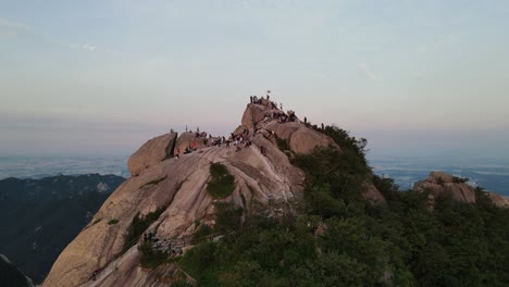 Aerial-shot-flying-over-Bukhansan-mountain-summit-with-tourists-and-hikers