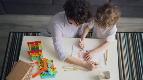 mother and son drawing together