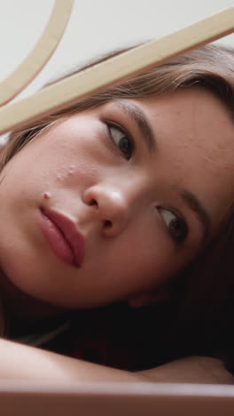 bored woman performs sadness on steps closeup. lady with symptoms of seasonal depressions lies on staircase. broken woman disinterested in living