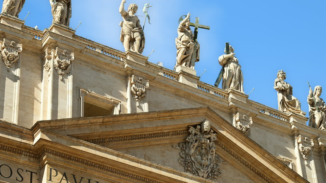 Statues on the Facade of St. Peter's Basilica on the blue sky background, in St. Peter's Square, Vatican City, Rome, Italy