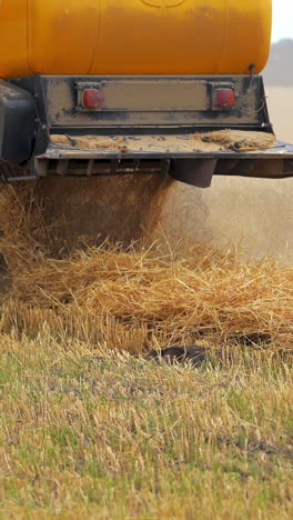 selective focus on harvesting machinery detail. heavy machinery is working the field. vertical video