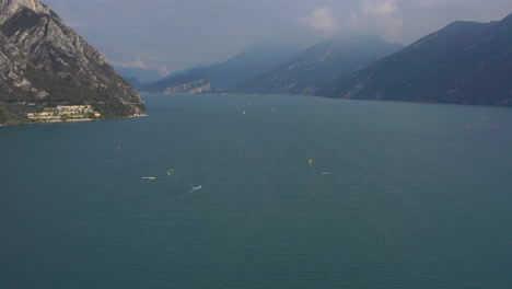 toma aérea estática de personas disfrutando de un día muy ventoso en el lago de garda, italia