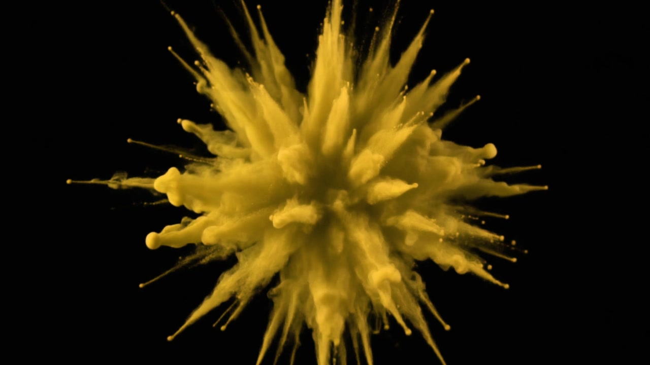 Yellow Powder Explosion Isolated on Black Background