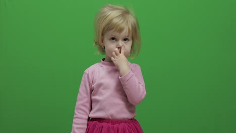 Happy-three-years-old-girl-picks-her-nose.-Cute-blonde-child