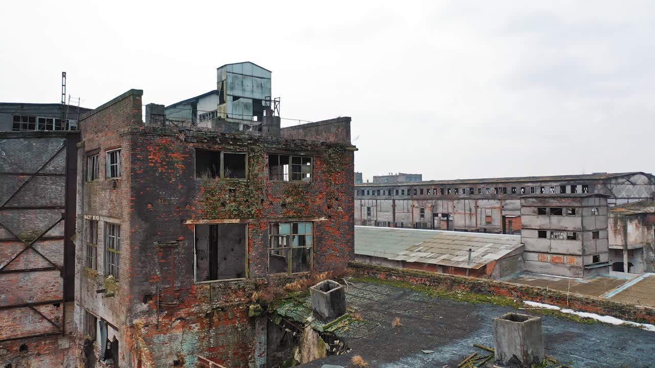 Abandoned factory with different buildings in industrial zone on the outskirts of the city? in aerial view.