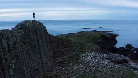 Ireland-Tourism---Person-Sight-Seeing-at-Giants-Causeway,-Popular-Tourist-Spot