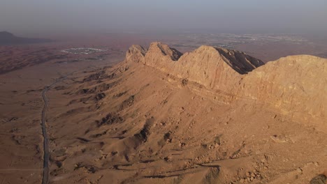 2021: rear drone view of uae's mleiha mountain range landscape, sharjah's mleiha desert, mountains in the united arab emirates, 4k footage