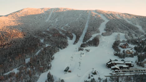 wide aerial view of saddleback ski area in rangeley, maine during golden hour sunset