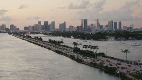 miami skyline at sunset with traffic on causeway
