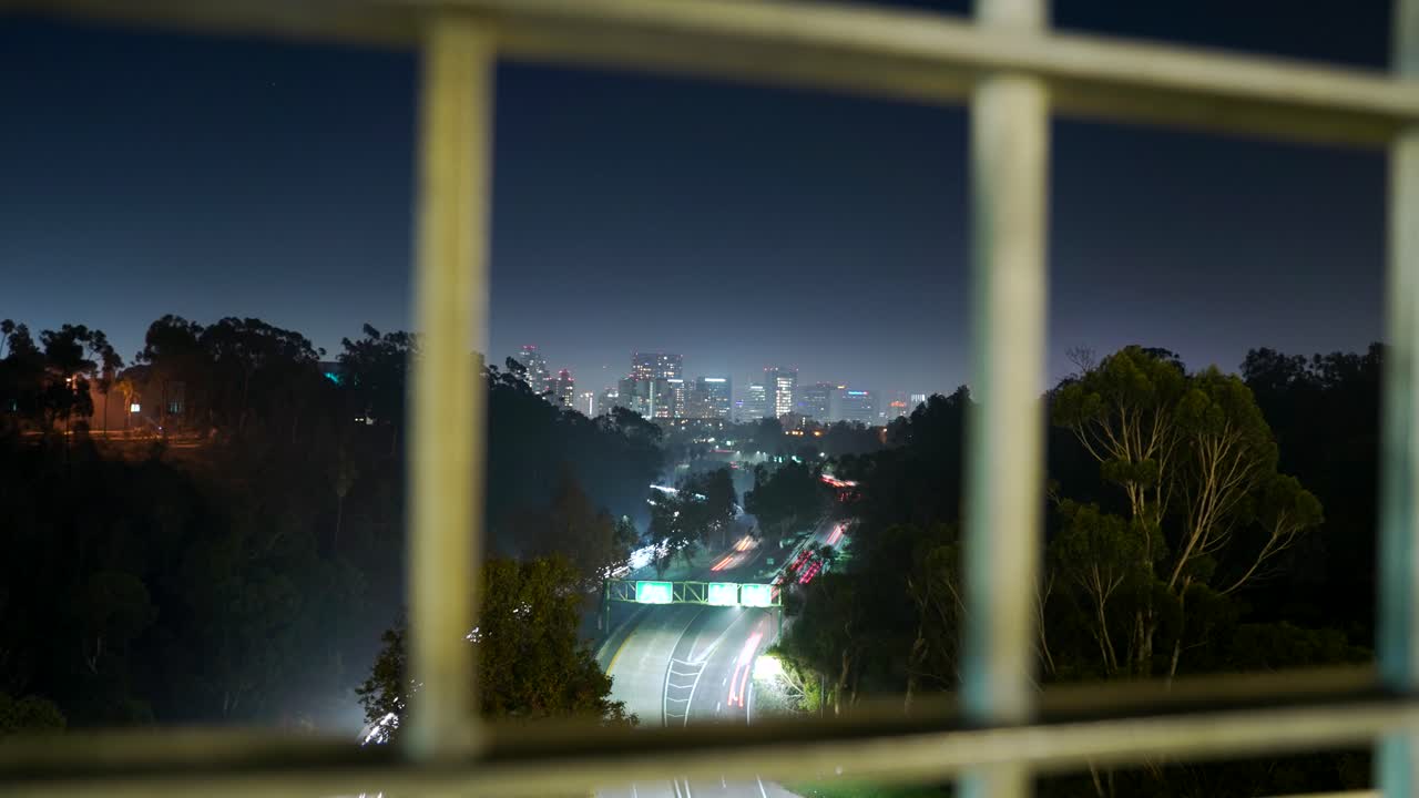 Night view of a city skyline from a bridge