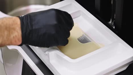 closeup of dentist prepping 3d printer plastic