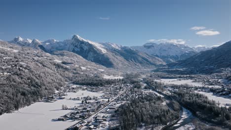 mountainous snow-covered landscape with a river winding through the valley