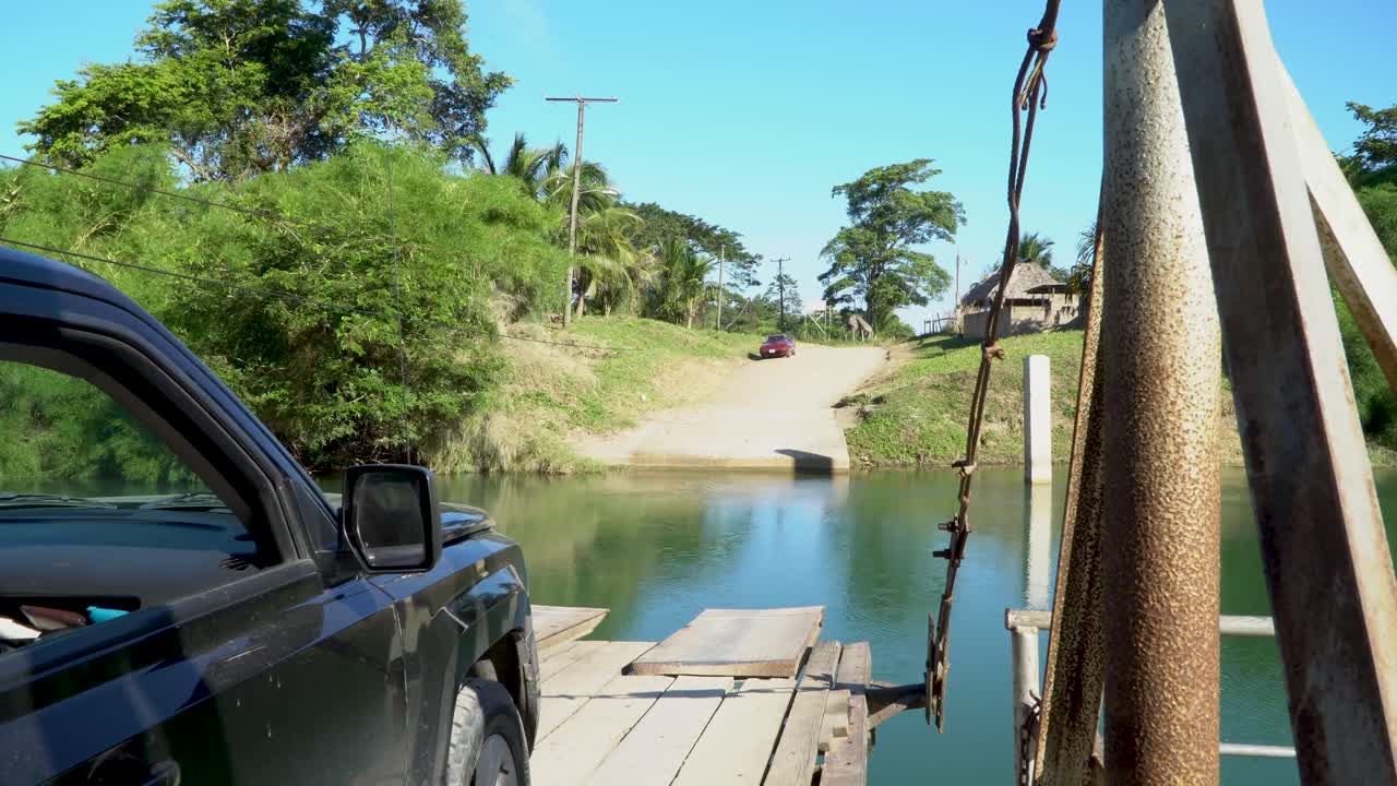 View from a hand-operated ferry crossing a small river in rural Belize