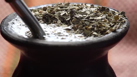 pouring water into a "mate" gourd