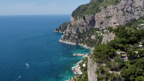 dramatic cliffs overlooking picturesque coastline of exotic capri, italy - aerial