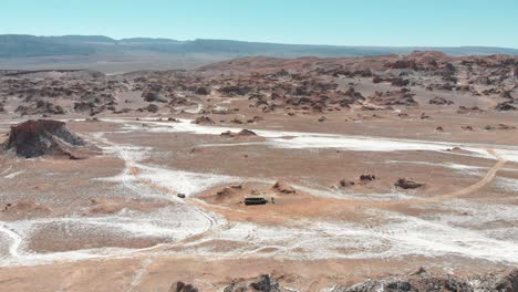 Cinematic-aerial-drone-shot-of-an-abandoned-bus-in-Atacama-desert,-South-America,-Chile