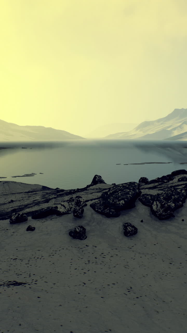 Towering mountains rise against a serene lake