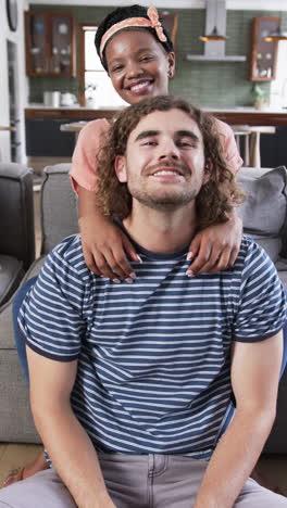 vertical video: diverse couple enjoying time together at home, at home