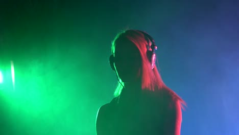 woman djing under neon lighting