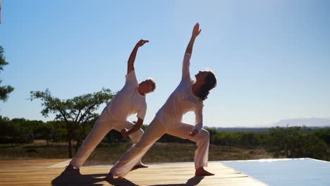 couple doing yoga in resort 4k