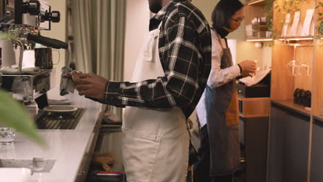 Two-Multiethnic-Waiters-Working-In-A-Coffee-Shop