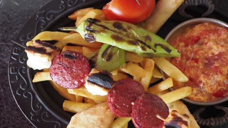 turkish breakfast platter with sucuk, fries, and tomato eggs